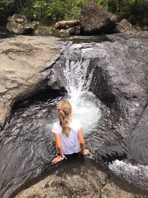 Visitor enjoying a waterfall experience
